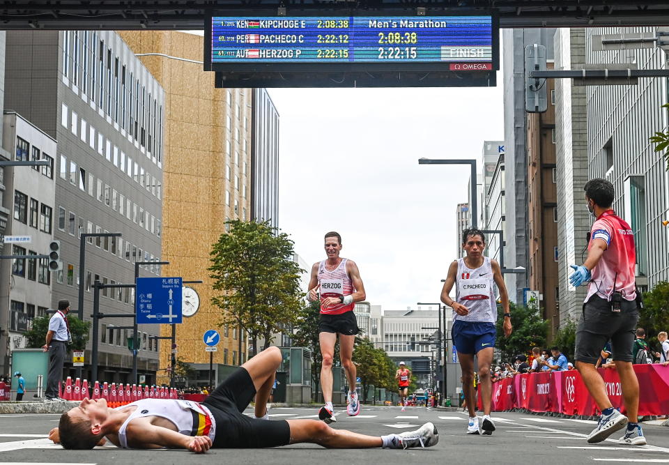 <p>Peter Herzog of Austria crosses the finish line during the men's marathon at Sapporo Odori Park on day 16 during the 2020 Tokyo Summer Olympic Games in Sapporo, Japan. (Photo By Ramsey Cardy/Sportsfile via Getty Images)</p> 