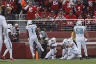 Miami Dolphins players celebrate after a touchdown pass from quarterback Tua Tagovailoa (1) to wide receiver Trent Sherfield, left, during the first half of an NFL football game against the San Francisco 49ers in Santa Clara, Calif., Sunday, Dec. 4, 2022. (AP Photo/Jed Jacobsohn)