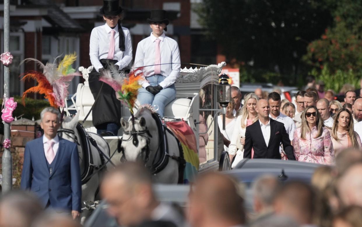 The parents of Elsie Dot Stancombe, David and Jenni, follow the horse-drawn hearse