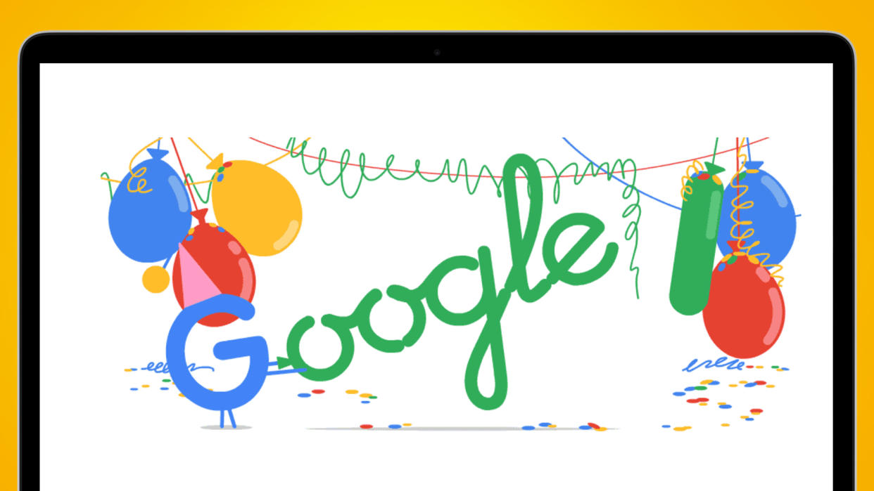  A laptop screen on a yellow background showing a Google logo made of birthday balloons 