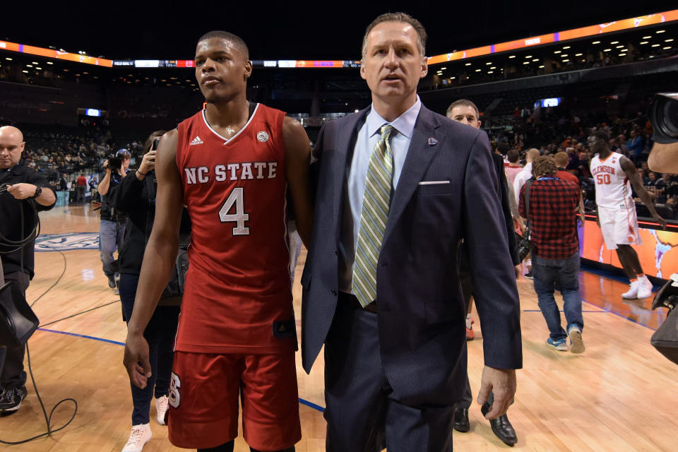 Dennis Smith Jr. and Mark Gottfried walk off after a NC State game during the 2017 ACC tournament. (Getty)