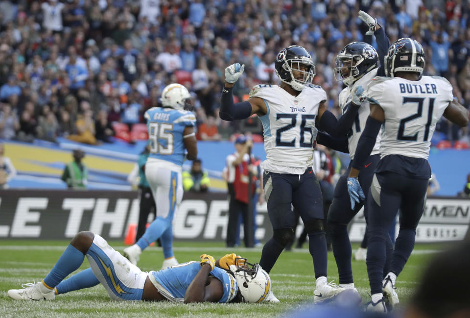 Los Angeles Chargers wide receiver Tyrell Williams (16), left, lies on the pitch after failing to catch the ball in the end zone during the second half of an NFL football game against Tennessee Titans at Wembley stadium in London, Sunday, Oct. 21, 2018. (AP Photo/Matt Dunham)
