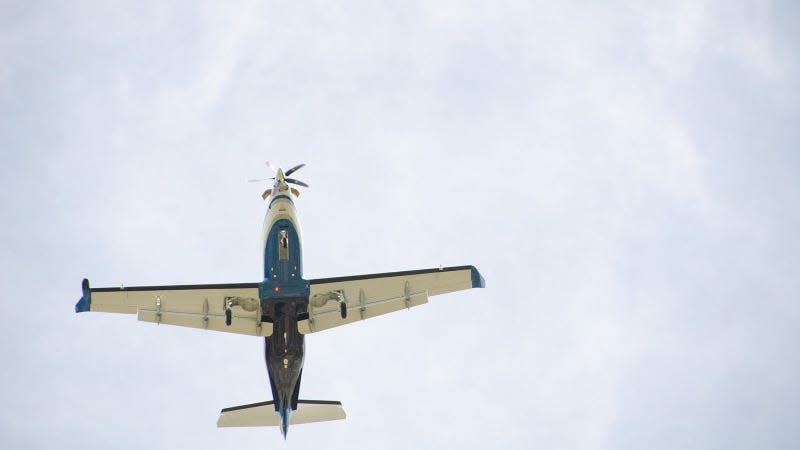 A photo of a small plane flying overhead. 