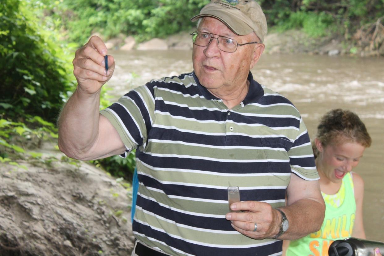 Erwin "Erv" Klaas teaching doing water testing with a group of kids in 2013.