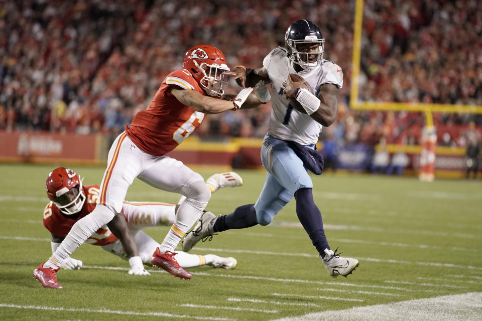 Tennessee Titans quarterback Malik Willis (7) runs with the ball as Kansas City Chiefs safety Bryan Cook (6) defends during the first half of an NFL football game Sunday, Nov. 6, 2022, in Kansas City, Mo. (AP Photo/Ed Zurga)