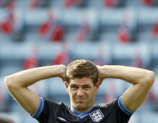 England captain Steven Gerrard stretches during a training session on the eve of a friendly match against Norway at the Ullevaal stadium in Oslo. England are hoping to exploit the feel-good factor created by Manchester City and Chelsea triumphs at home and abroad as a new era under Roy Hodgson kicks off against Norway