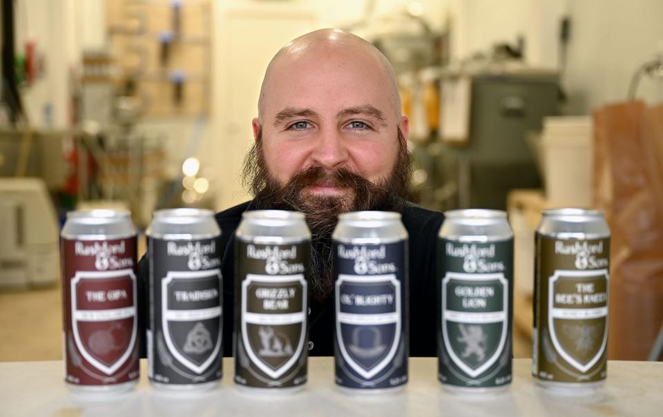 Mike Rushford, head brewer at Rushford & Sons Brewery in Upton, with cans of Rushand & Sons beer.