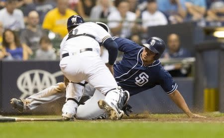 Aug 7, 2018; Milwaukee, WI, USA; San Diego Padres left fielder Hunter Renfroe (10) is tagged out on a play at the plate by Milwaukee Brewers catcher Manny Pina (9) during the seventh inning at Miller Park. Mandatory Credit: Jeff Hanisch-USA TODAY Sports