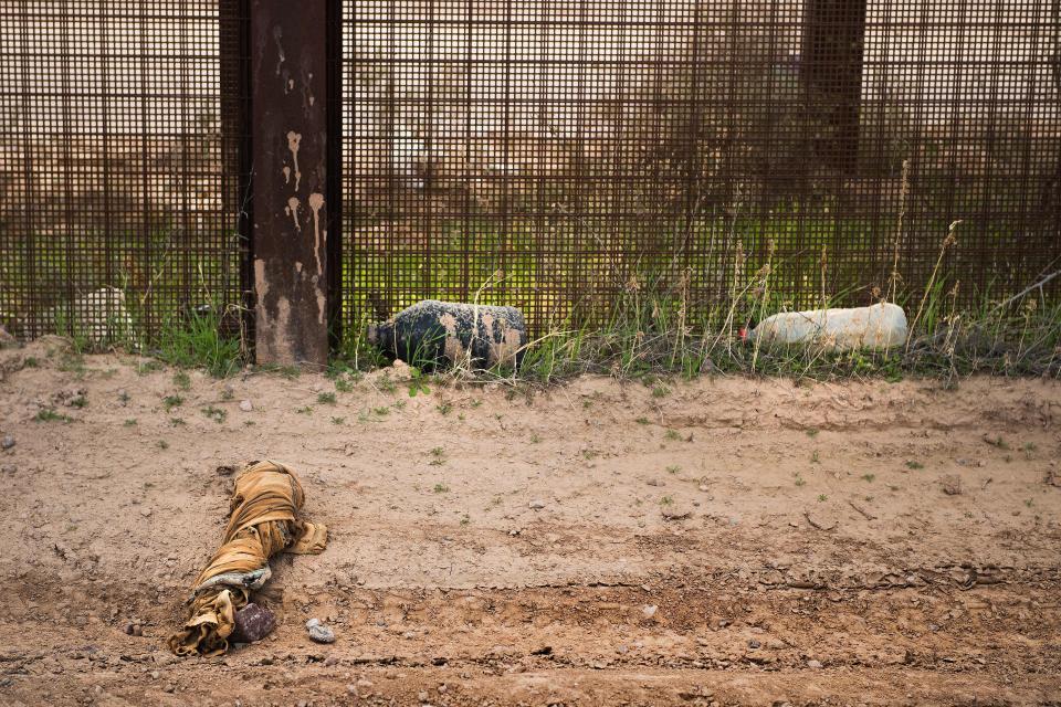 A&nbsp;&nbsp;swath of fabric and empty water jugs lay next to the border fence outside Lukeville, Arizona, on Feb. 16, 2017. (Photo: JIM WATSON via Getty Images)