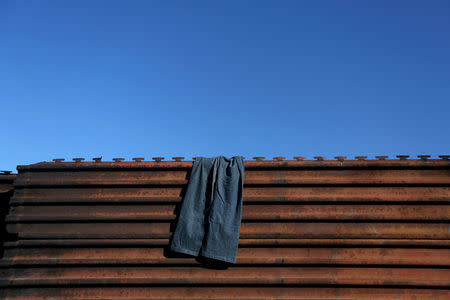 Pants hang on a section of the fence separating Mexico and the United States, in Tijuana, Mexico. REUTERS/Edgard Garrido