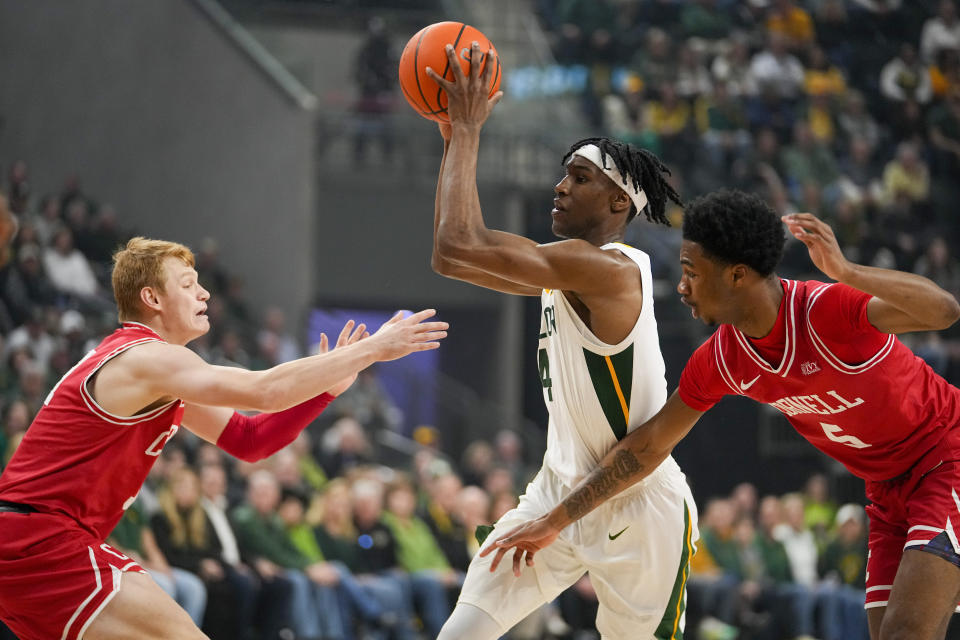 Baylor guard Ja'Kobe Walter, center, drives to the basket against Cornell guard Cooper Noard, left, and guard Jacob Beccles during the first half of an NCAA college basketball game, Tuesday, Jan. 2, 2024, in Waco, Texas. (AP Photo/Julio Cortez)