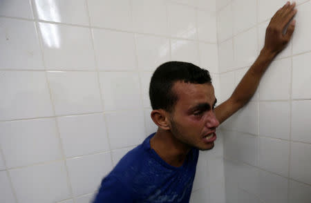 A relative of a Palestinian Islamic Jihad militant, who was killed in an Israeli tank shelling that targeted an observation post, reacts at a hospital in the southern Gaza Strip May 27, 2018. REUTERS/Ibraheem Abu Mustafa