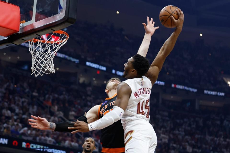 Cleveland Cavaliers guard Donovan Mitchell (45) shoots against New York Knicks center Isaiah Hartenstein during the first half of Game 2 of an NBA basketball first-round playoff series Tuesday, April 18, 2023, in Cleveland. (AP Photo/Ron Schwane)