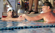 Michael Phelps, left, congratulates Ryan Lochte on Lochte's win in the 100-meter butterfly final during the Arena Grand Prix, Thursday, April 24, 2014, in Mesa, Ariz. Phelps was competing for the first time since the 2012 London Olympics. (AP Photo/Matt York)