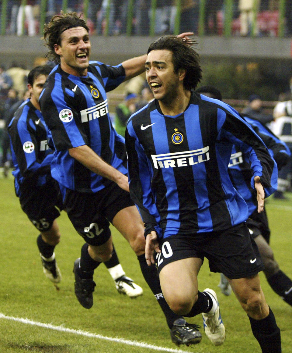 FILE - In this file photo taken on Jan 9, 2005, Inter Milan forward Alvaro Recoba, right, of Uruguay celebrates scoring against Sampdoria with teammate Christian Vieri during the Italian major league soccer match at the San Siro stadium in Milan, Italy. Christian Vieri’s informal talk show on Instagram Live has quickly gained a devoted audience of followers during the coronavirus lockdown. On a nightly basis, Vieri calls up his old teammates scattered throughout Italy and around the world to reminisce about their time together in the late 1990s and early 2000s. Guests have included international stars like Ronaldo, Hernán Crespo and Juan Sebastián Verón; along with Italians Francesco Totti, Paolo Maldini, Filippo Inzaghi, Alessandro Nesta and Marco Materazzi. (AP Photo/Luca Bruno)