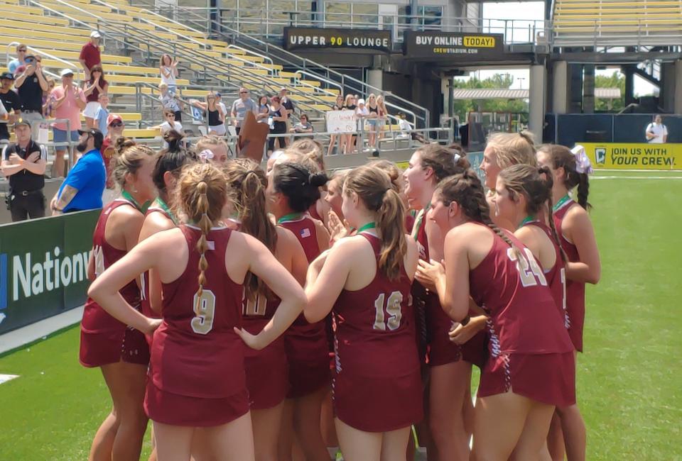 Watterson players hoist the Division II state championship trophy Saturday at Historic Crew Stadium after defeating Shaker Heights Hathaway Brown 10-8.