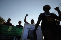 <p>Demonstrators march through the South Shore neighborhood protesting the shooting death of 37-year-old Harith Augustus on July 16, 2018 in Chicago, Ill. (Photo: Scott Olson/Getty Images) </p>