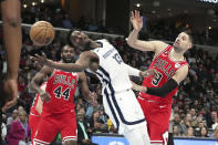 Memphis Grizzlies' Jaren Jackson Jr. reaches for the ball as Chicago Bulls' Nikola Vucevic (9) defends during the first half of an NBA basketball game Tuesday, Feb. 7, 2023, in Memphis, Tenn. (AP Photo/Karen Pulfer Focht)