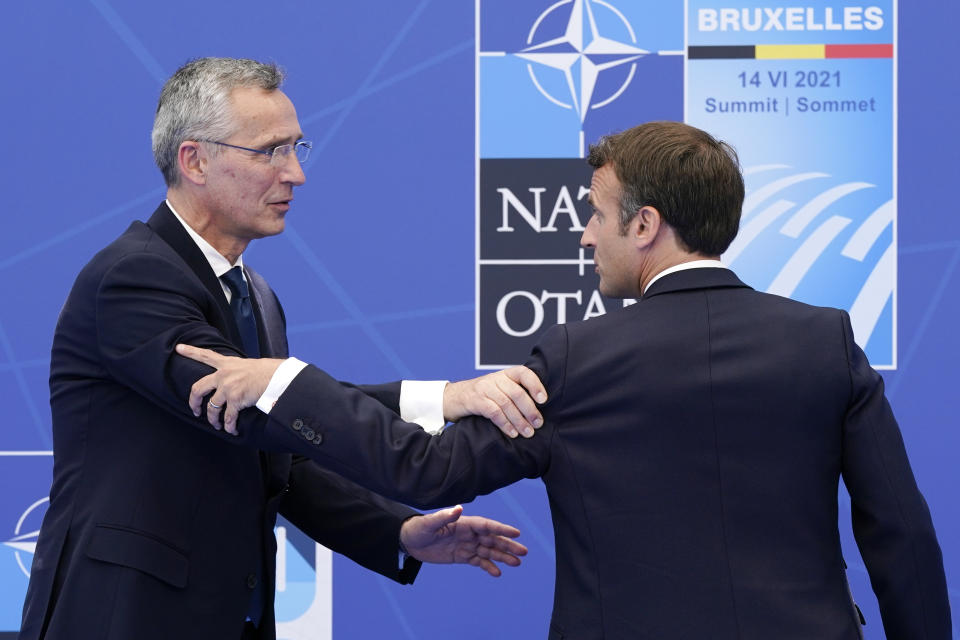 French President Emmanuel Macron, right, speaks with NATO Secretary General Jens Stoltenberg after posing for photos at the NATO summit at NATO headquarters in Brussels, Monday, June 14, 2021. (AP Photo/Patrick Semansky, Pool)