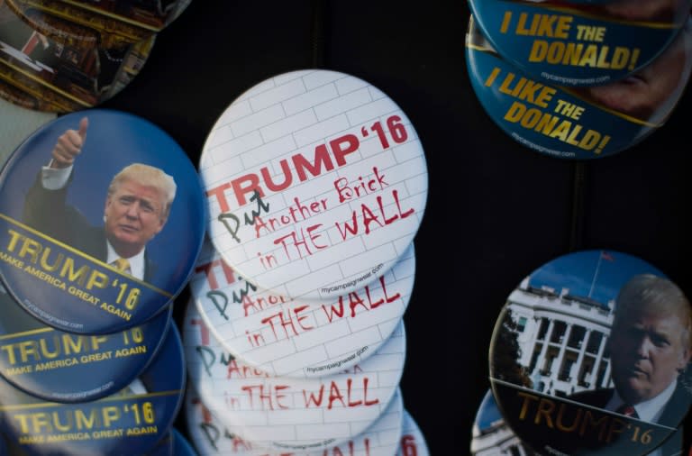 Buttons referring to Republican Presidential candidate Donald Trump's immigration policies for sale outside a Trump Rally in Marshalltown, Iowa, January 26, 2016, ahead of the Iowa Caucus