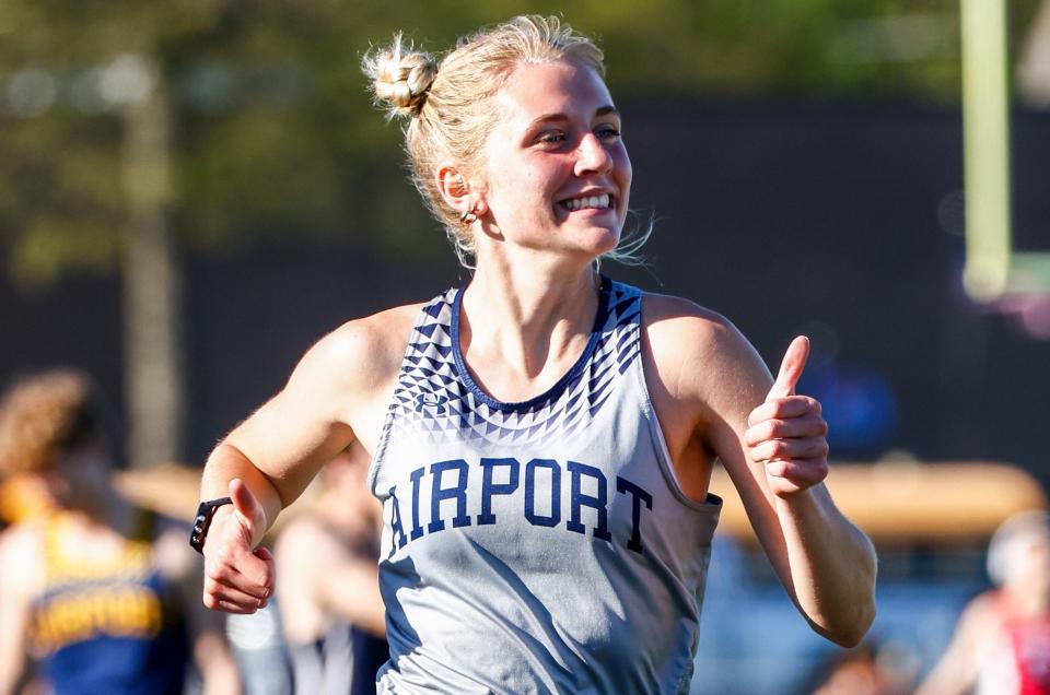 Courtney Bovair gives a thumbs up as she runs for Airport during a meet against Grosse Ile on Tuesday, April 30, 2024.