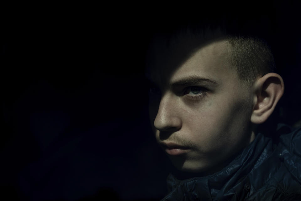 Dmytro Zhdanevych, 15, looks though the window of a car as he is evacuated from the village of Lyptsi to Kharkiv, Ukraine, on Monday, April 15, 2024. (AP Photo/Evgeniy Maloletka)