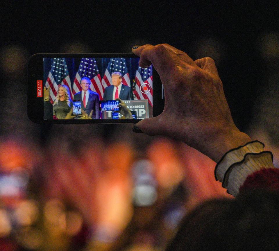 A Trump supporter video records the former president during a rally to celebrate his victory in the Feb. 8, 2024, Nevada caucus, at the Treasure Island casino hotel in Las Vegas.