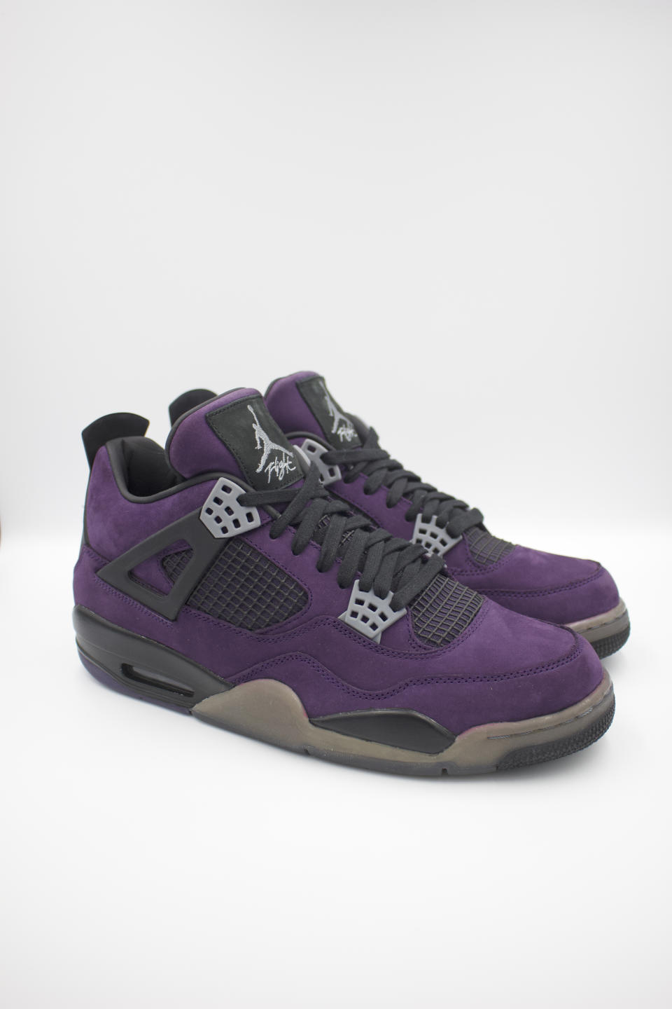 The Travis Scott Jordan 4 Purple Friends & Family pair