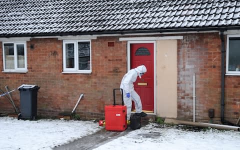 A police forensics officer outside the property in Brownhills, near Walsall - Credit: Matthew Cooper /PA