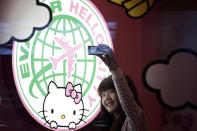 A passenger takes a self-portrait with an Eva Airlines' Hello Kitty-themed light box in Taoyuan International Airport, northern Taiwan, April 30, 2012. Taiwan's second-largest carrier, Eva Airlines, and Japan's comic company, Sanrio, which owns the Hello Kitty brand, collaborated on the second generation Hello Kitty-themed aircraft which was launched on October 2011. There are currently three Hello Kitty-themed Airbus A330-300 aircrafts flying between cities such as Taipei, Fukuoka, Narita, Sapporo, Incheon, Hong Kong and Guam. REUTERS/Pichi Chuang