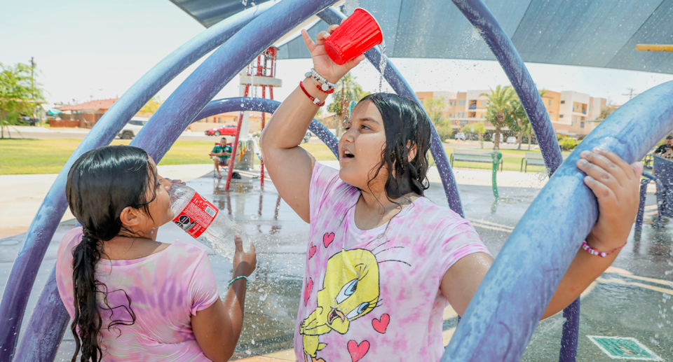 Girls pour water over their heads in Texas.