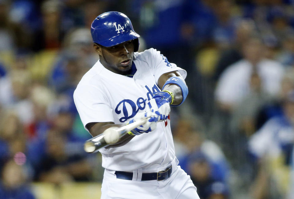 Los Angeles Dodgers' Yasiel Puig hits a solo home run off of San Francisco Giants starting pitcher Madison Bumgarner during the sixth inning of a baseball game, Friday, May 9, 2014, in Los Angeles. (AP Photo/Danny Moloshok)