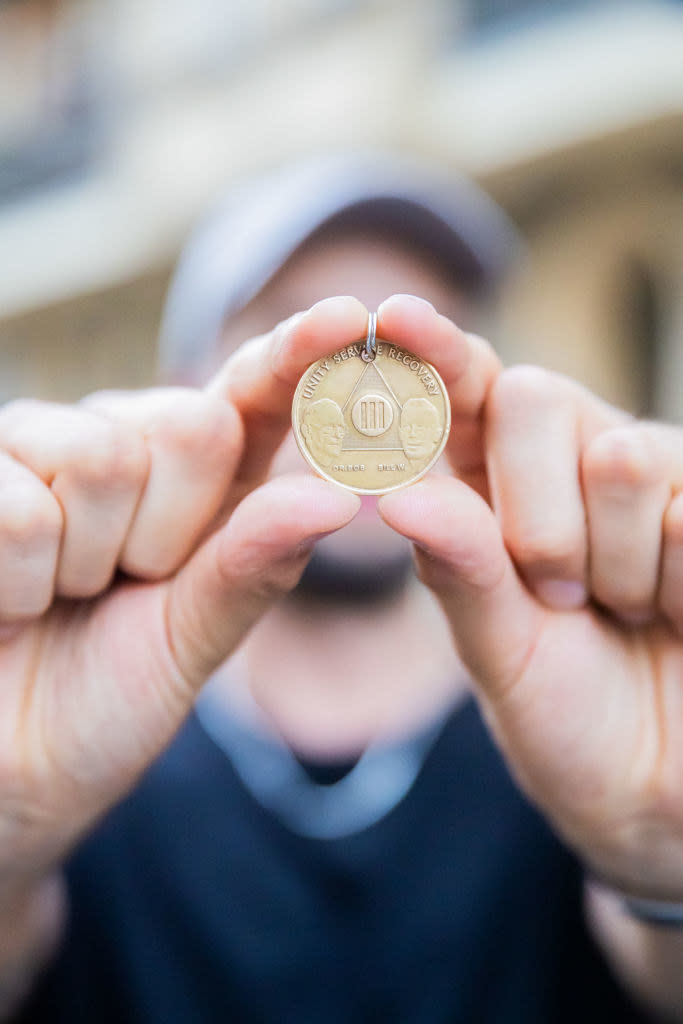 holding up an alcoholics anonymous three years sobriety chip