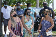 A group waits to get a COVID-19 test, Saturday, July 31, 2021, in North Miami, Fla. Federal health officials say Florida has reported 21,683 new cases of COVID-19, the state's highest one-day total since the start of the pandemic. The state has become the new national epicenter for the virus, accounting for around a fifth of all new cases in the U.S. Florida Gov. Ron DeSantis has resisted mandatory mask mandates and vaccine. (AP Photo/Marta Lavandier)