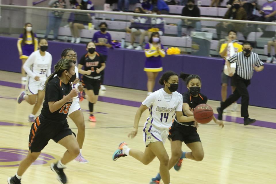 Kirtland Central's Jaylene Harris-Rhea races to the basket chased by Gallup's Daliyah Morris during their game on Tuesday, Jan. 18, 2022 at Bronco Arena.