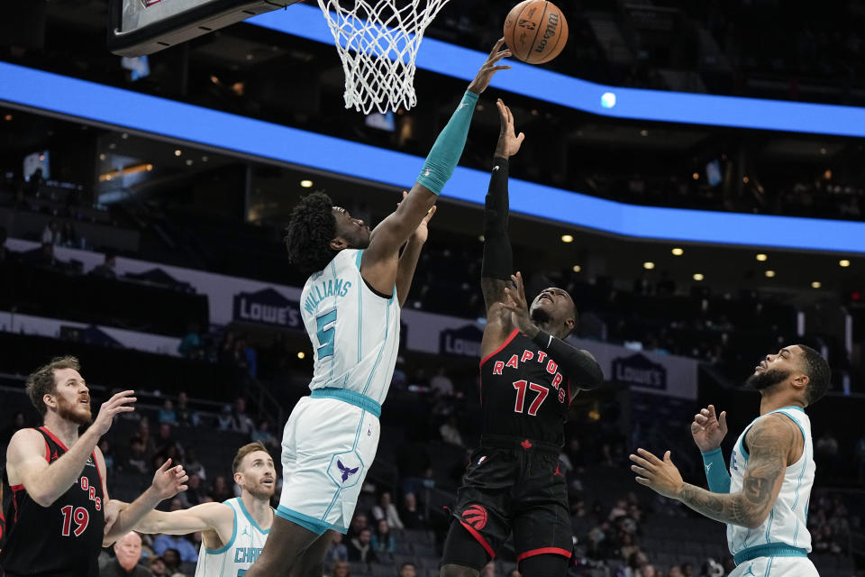 Charlotte Hornets center Mark Williams blocks a shot by Toronto Raptors guard Dennis Schroder during the first half of an NBA basketball game Friday, Dec. 8, 2023, in Charlotte, N.C. (AP Photo/Chris Carlson)