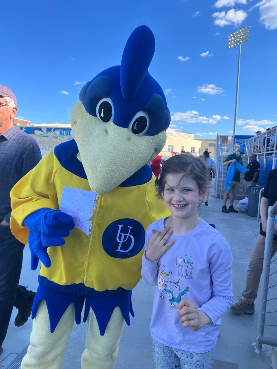 Cassie stands next to YoUDee, the University of Delaware's mascot.