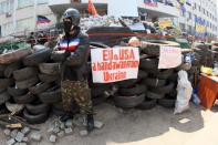 A file picture taken on April 17, 2014 shows a pro-Russian activist guarding a barricade outside the local government building in Ukraine's southeastern port city of Mariupol