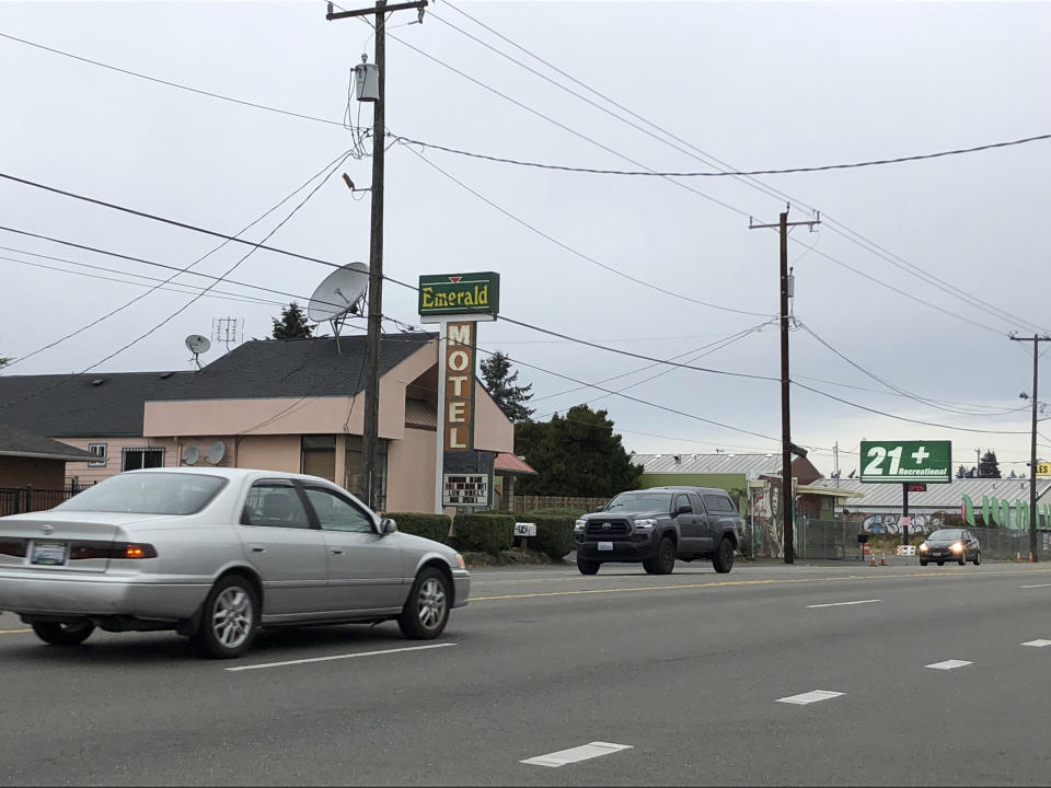 Cars drive by the Emerald Motel in North Seattle on Friday, Nov. 11, 2022. Prosecutors say a 20-year-old woman made a harrowing escape from her vicious pimp outside the motel on the night of Saturday, Nov. 5, before being rescued by a ride-share driver who engaged in a gunfight with the man. (AP Photo/Gene Johnson)