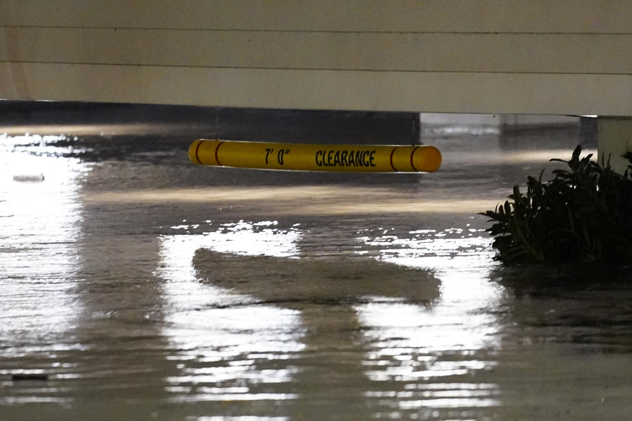 Flooding reaches close to a 7-foot clearance sign in the Manayunk section of Philadelphia on Thursday.