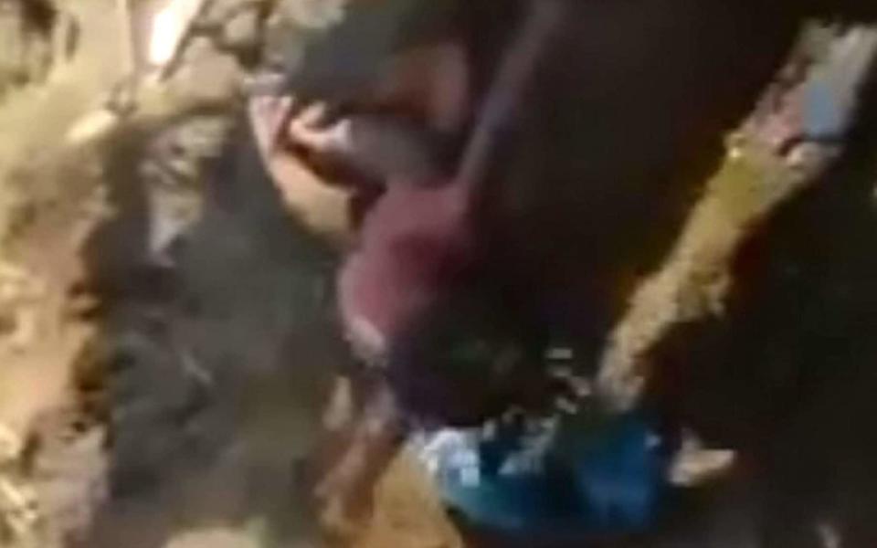 The moment a newborn baby girl was rescued after being buried alive - Credit: SWNS.com