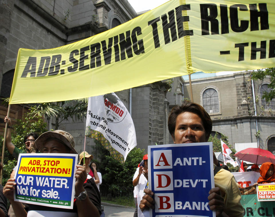 Protesters display placards during a rally coinciding with the 45th Annual Meeting of the Board of Governors of the Asian Development Bank Wednesday, May 2, 2012, in Manila, Philippines. The protesters were rallying against the bank's alleged role in the privatization of energy and water sectors and in pushing coal and other dirty technologies in Asia and the Pacific. (AP Photo/Pat Roque)