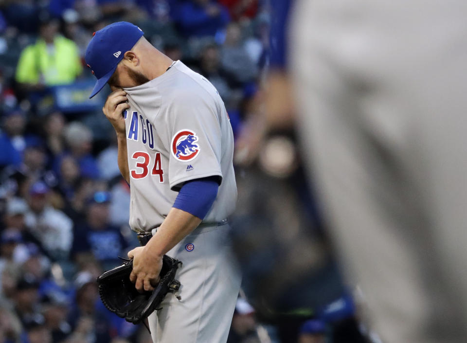 Chicago Cubs starting pitcher Jon Lester wipes his face after throwing error by shortstop Javier Baez during the first inning of a baseball game against the Chicago White Sox Saturday, Sept. 22, 2018, in Chicago. (AP Photo/Nam Y. Huh)