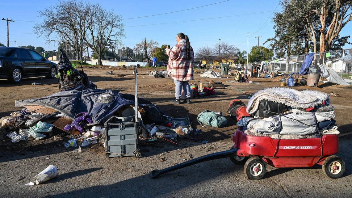 Homeless advocate Dez Martinez records Fresno’s Homeless Assistance Response Team (HART) as they beginsa homeless camp cleanup operation behind several shelters on Parkway Drive in Fresno on Wednesday, Feb. 1, 2023