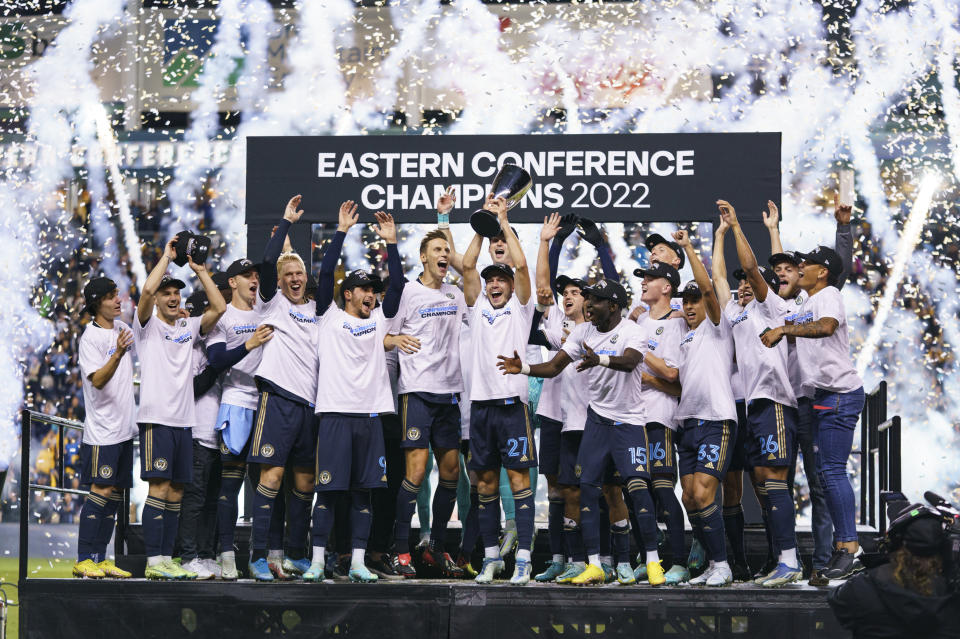 FILE -Philadelphia Union's Kai Wagner, center, lifts the trophy as the Philadelphia Union celebrates the win following the MLS soccer match against New York City FC, Sunday, Oct. 30, 2022, in Chester, Pa. The push toward the World Cup in 2026 begins now for Major League Soccer. The league, entering its 28th season this year, has a new team in St. Louis City and a new media deal with Apple TV. This season will also feature an expanded Leagues Cup, which will involve all of the MLS and Liga MX teams for the first time. (AP Photo/Chris Szagola, File)