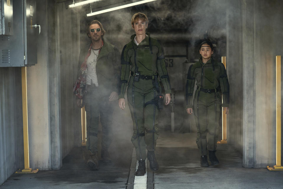This image released by Warner Bros Pictures shows Dan Stevens, left, Rebecca Hall and Kaylee Hottle in a scene from "Godzilla X Kong: The New Empire." (Warner Bros. Pictures via AP)