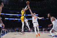 New York Knicks guard Donte DiVincenzo (0) guards Indiana Pacers guard Tyrese Haliburton (0) as Halliburton shoots during the first half of Game 7 in an NBA basketball second-round playoff series, Sunday, May 19, 2024, in New York. (AP Photo/Julia Nikhinson)