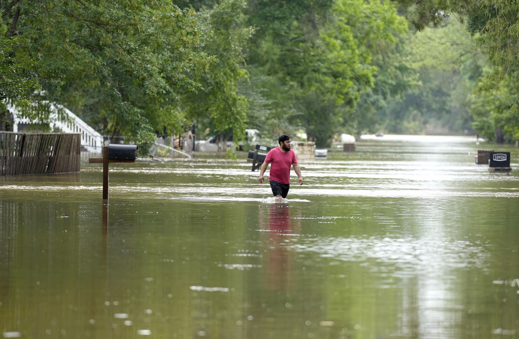 A man walks through floodwaters 