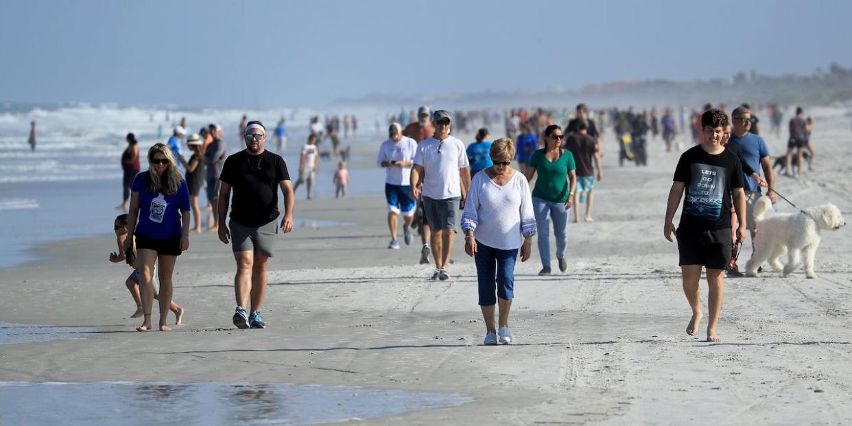 People are seen at the beach on April 17, 2020 in Jacksonville Beach, Florida.