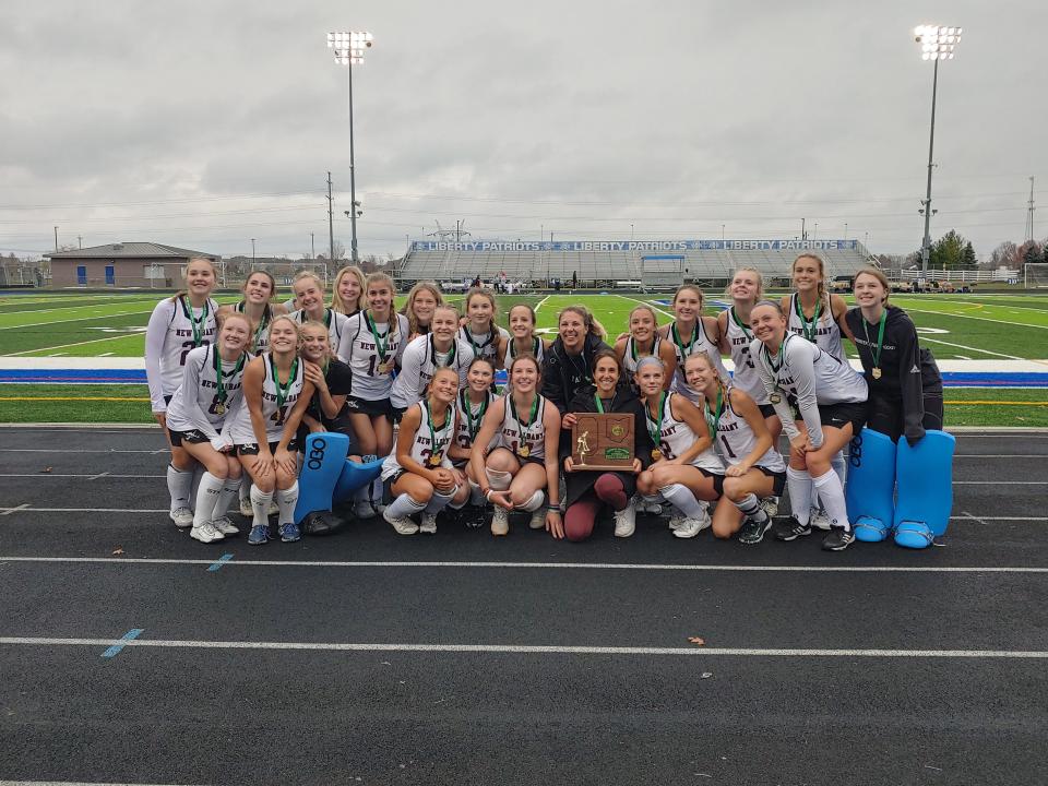 The New Albany field hockey team poses with its first regional championship trophy Saturday after a 3-1 win over Upper Arlington at Olentangy Liberty.